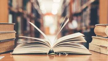 An open book on a table in the library.