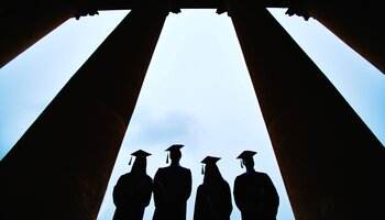 image of 4 people standing between columns