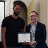 Department head Luvell Anderson presents professor Nir Ben-Moshe with the Excellence in Undergraduate Teaching Award
