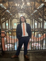 Noah Meyerhoff stands on a indoor balcony